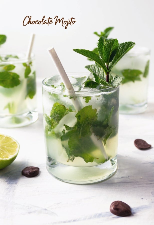 A closeup of chocolate mojito in a glass with fresh mint and a straw. 