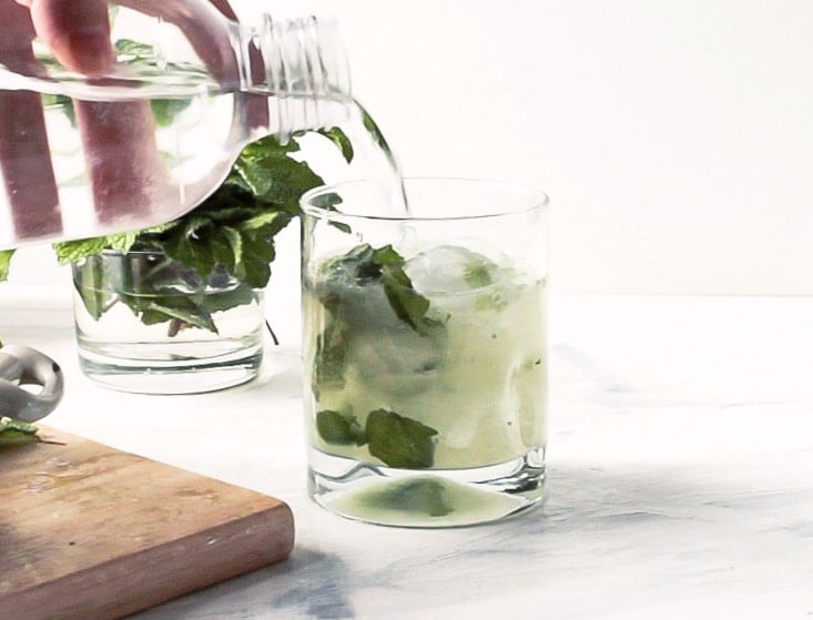 Pouring seltzer in a chocolate mojito