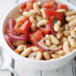 Italian cannellini beans tossed with plum tomatoes, red onion and fresh basil in a balsamic vinaigrette.