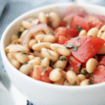 Italian cannellini beans tossed with plum tomatoes, red onion and fresh basil in a balsamic vinaigrette.