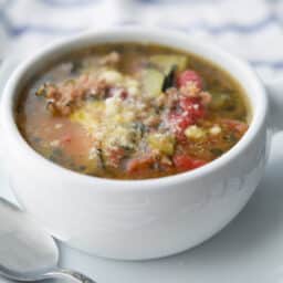 Sausage and Zucchini Soup in white crock