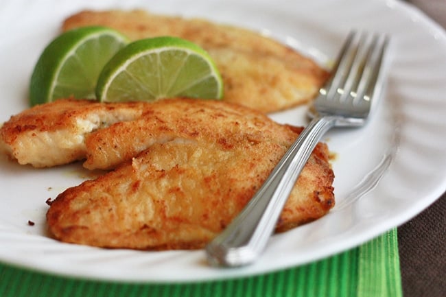 A plate of food with a fork, with Fish and Tilapia