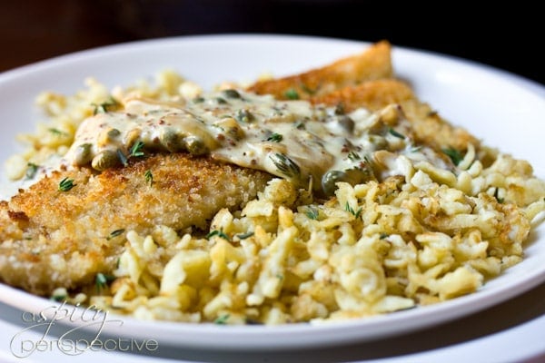 A plate of food with rice, with Trout and Schnitzel