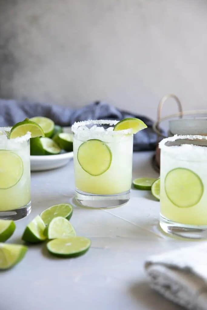 Classic margarita in a glass with limes. 