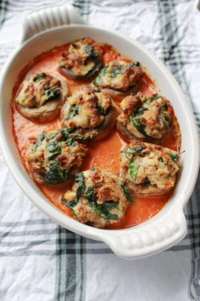 Four Cheese and Sausage Stuffed Mushrooms in a white dish