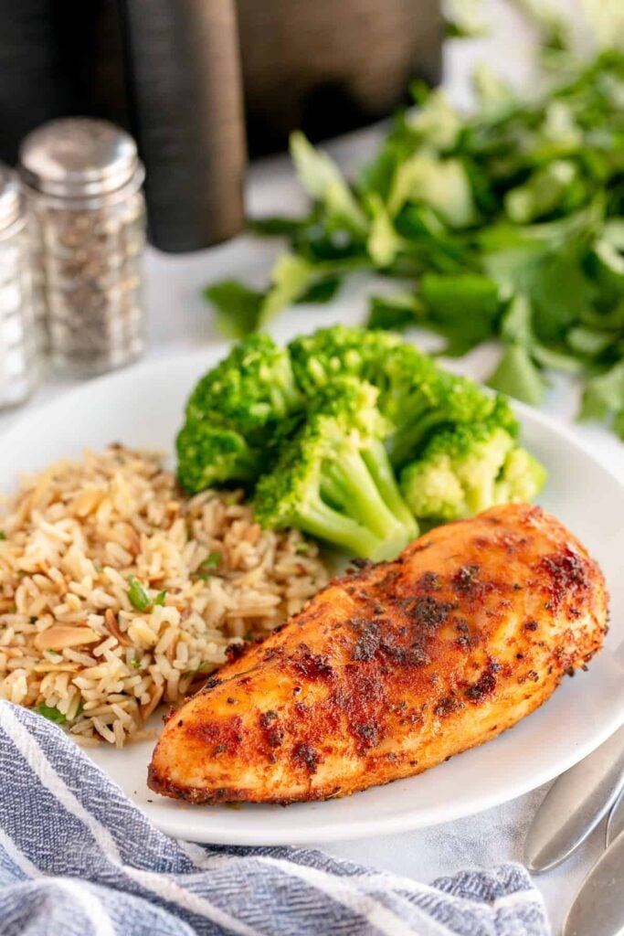 air fryer chicken breast on a plate with rice and broccoli