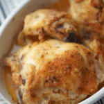 Baked Cajun Chicken Thighs in a white oven safe baking dish.