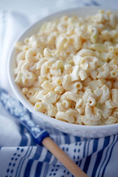 Creamy Deviled Egg Macaroni Salad in a white bowl.