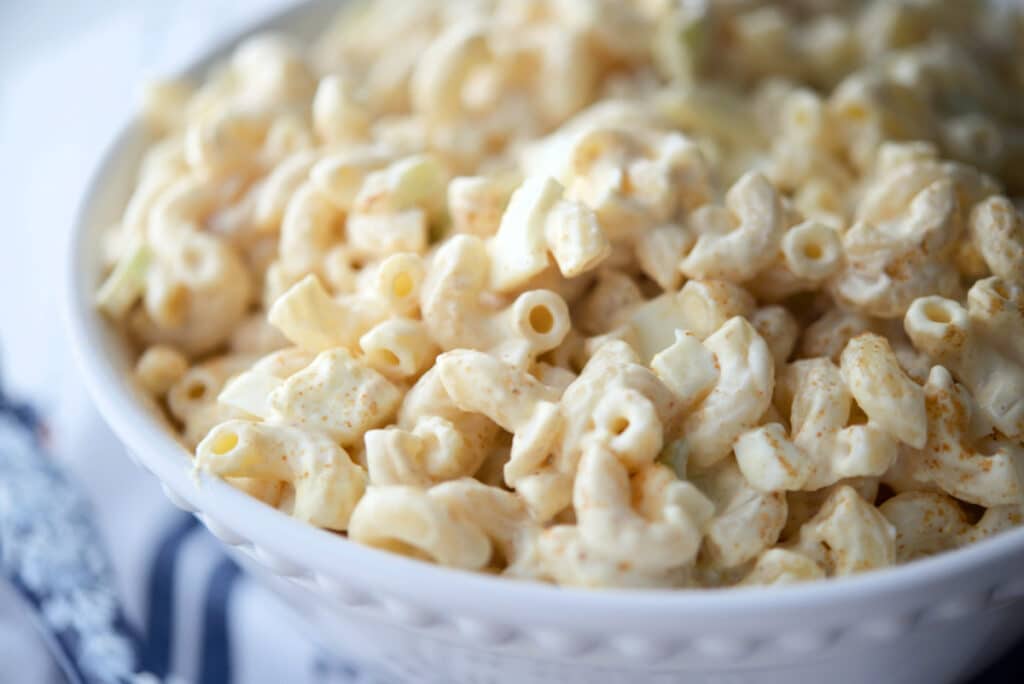 A closeup of deviled egg macaroni salad in a bowl.