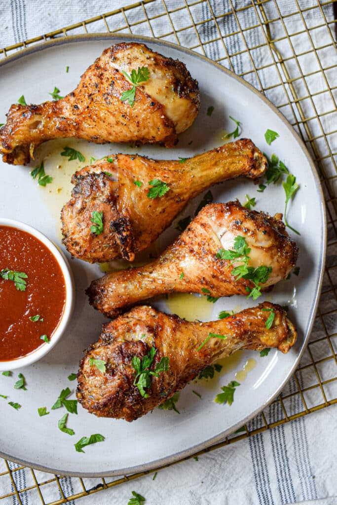 Chicken legs cooked in the air fryer on a plate