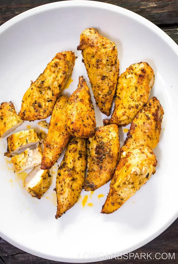 chicken tenders on a white plate. 