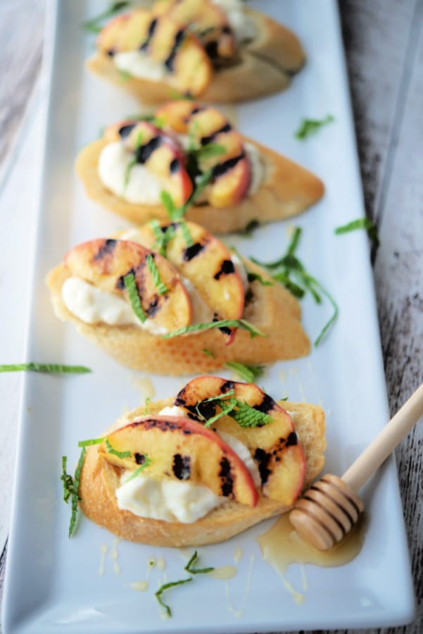 A platter of crostini with grilled peaches