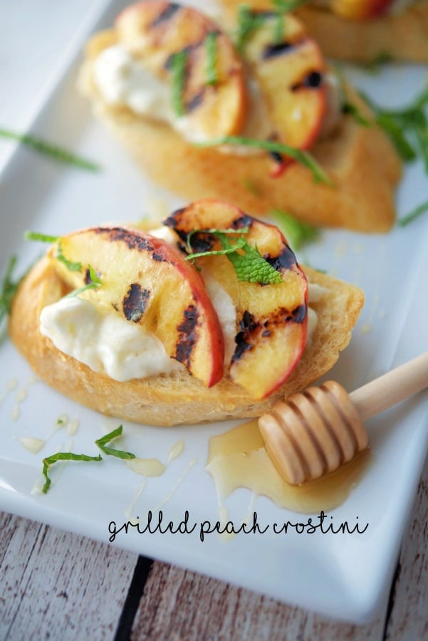 A close up of grilled peaches on top of toasted bread