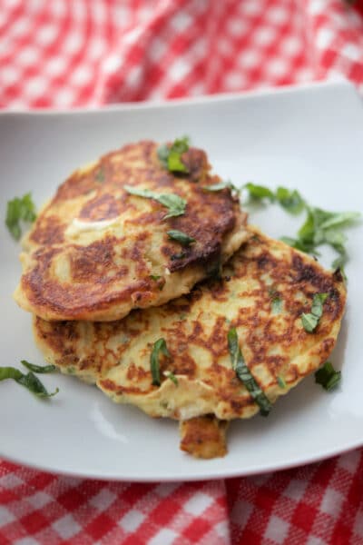 Mozzarella Basil Fritters on a white plate.