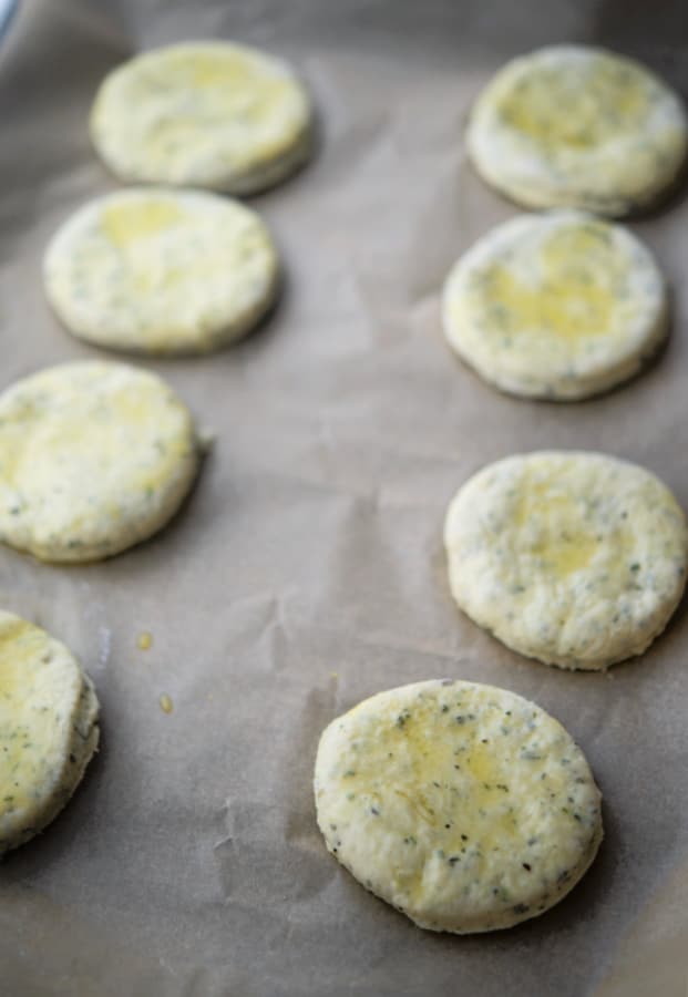 Rosemary oil biscuits on a baking sheet before being cooked.