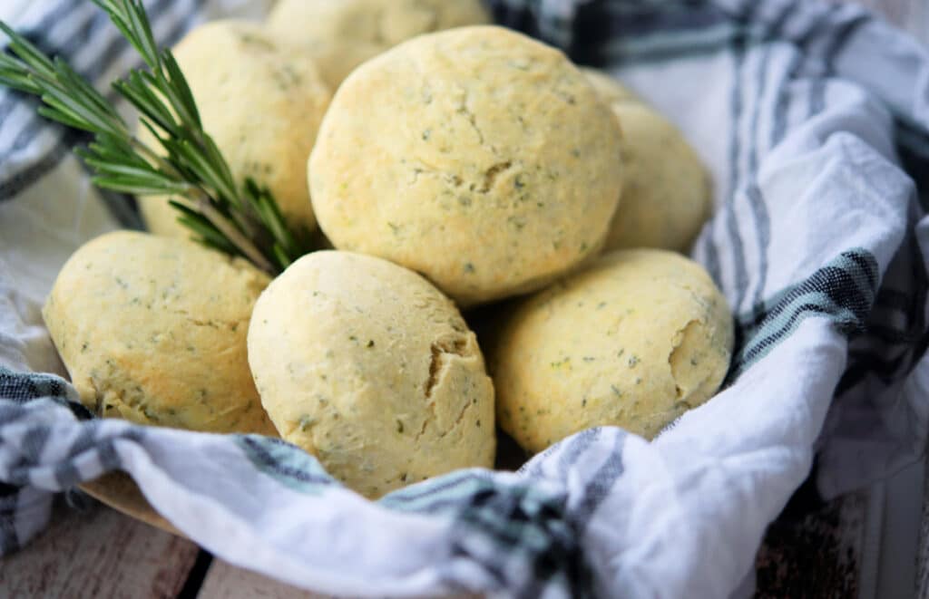 Rosemary biscuits in a basket with a white and green napkin