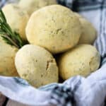 Rosemary biscuits in a basket with a white and green napkin