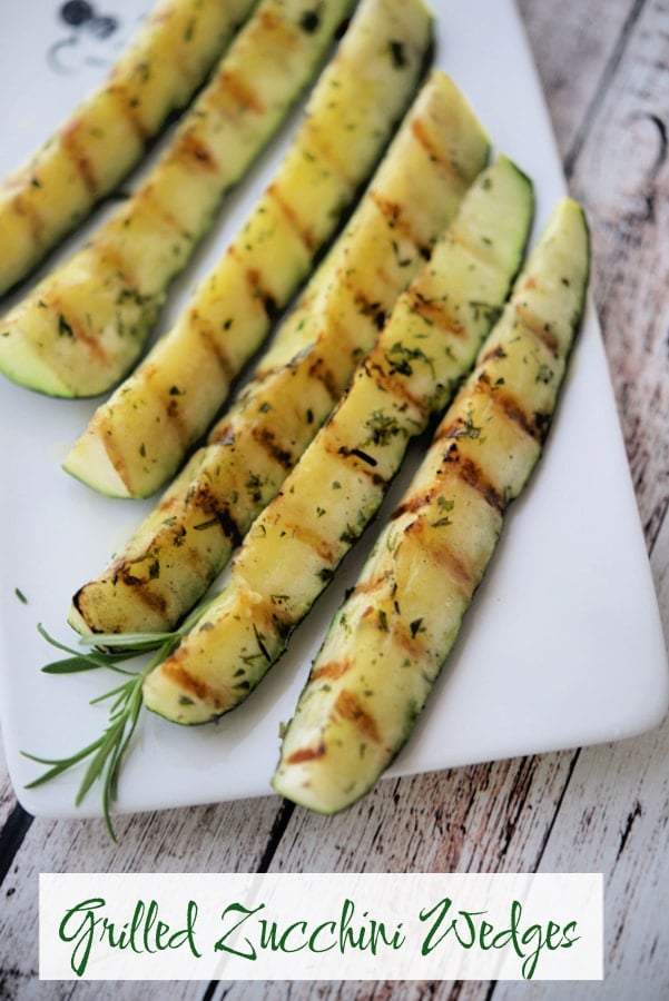 Grilled Zucchini Wedges with rosemary on a wooden table