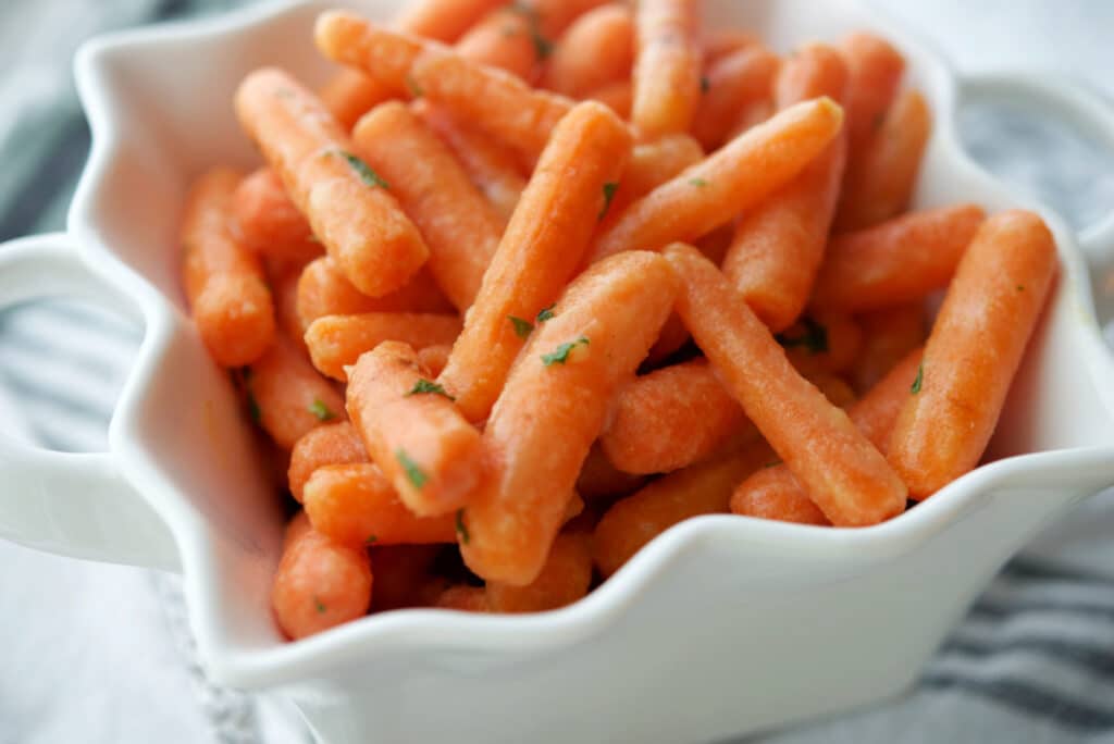 A close up of carrots in a white dish