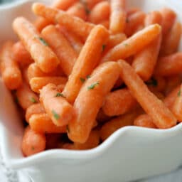 A close up of carrots in a white dish