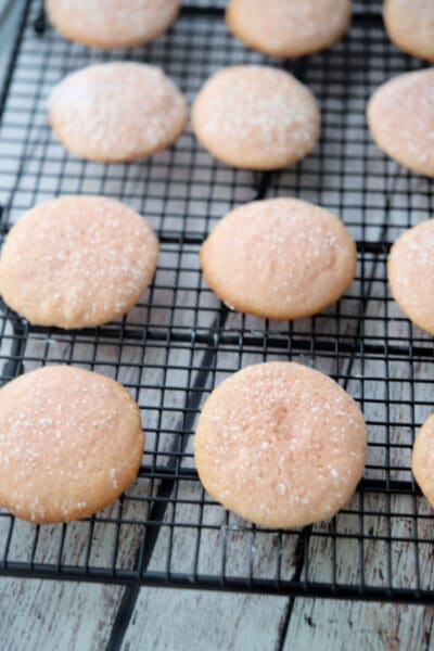 Pink Lemonade Sugar Cookies on a black cooling rack.