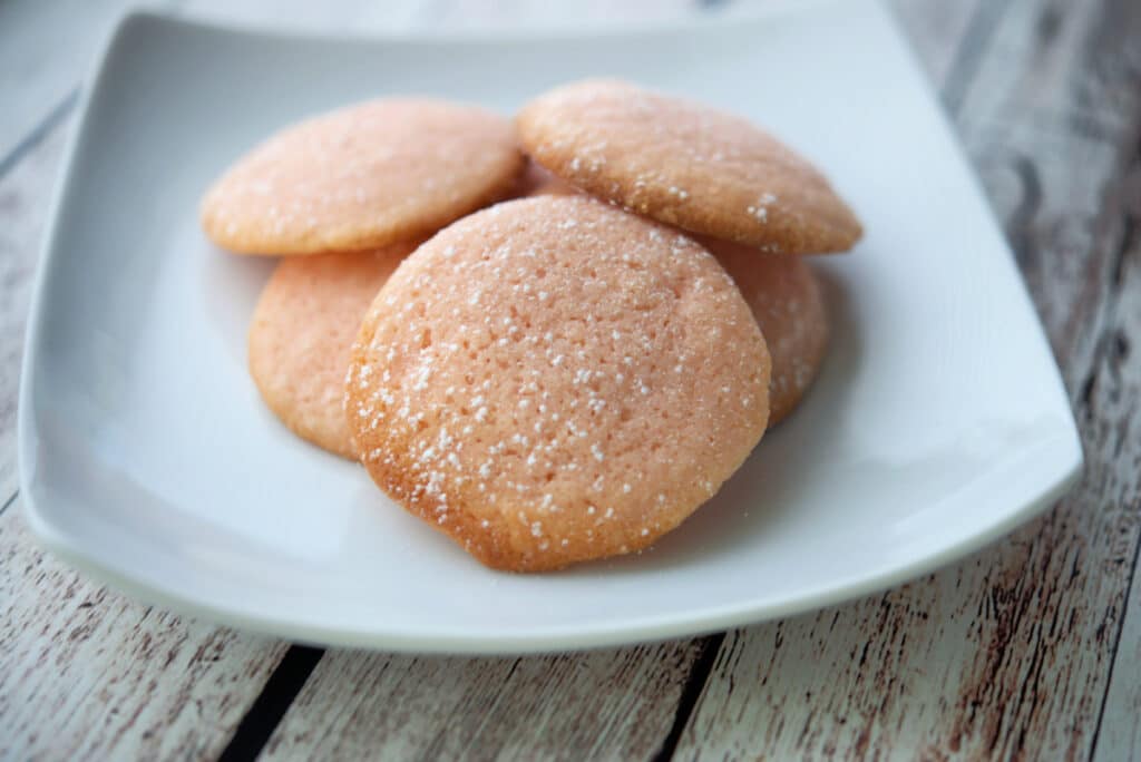 Lemon sugar cookies on a white plate. 