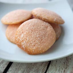 Lemon sugar cookies on a white plate.