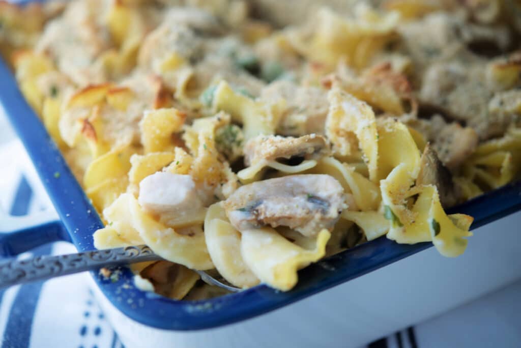 A close up of a chicken casserole on a spoon