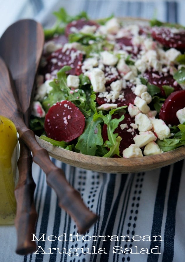 Arugula salad in a wooden bowl.