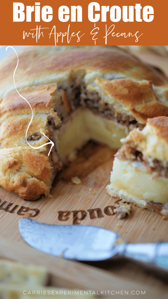 Brie topped with apples and pecans and covered with dough and baked.