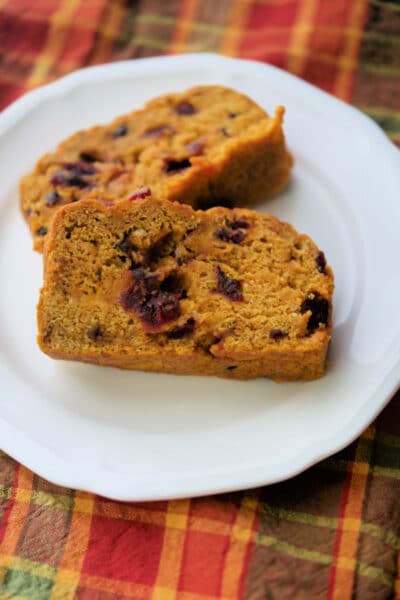 Two slices of pumpkin bread on a white plate