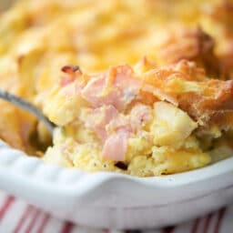 A close up of a breakfast casserole on a spoon