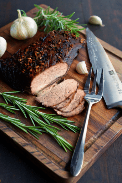 a beef brisket on a wooden cutting board