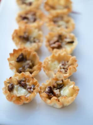 Baked Brie Bites with pecans and bourbon on a plate