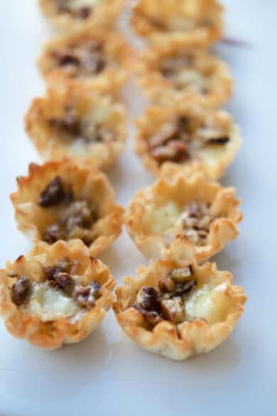 Baked Brie Bites with pecans and bourbon on a plate