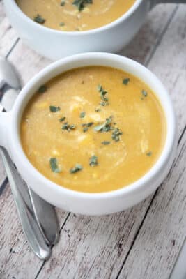 Squash and apple soup in a white crock