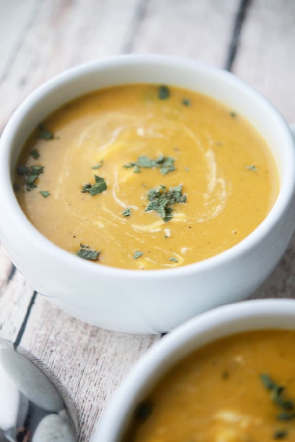 Soup in a crock on a wooden surface