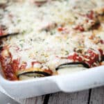 Rolled eggplant topped with sauce and cheese.