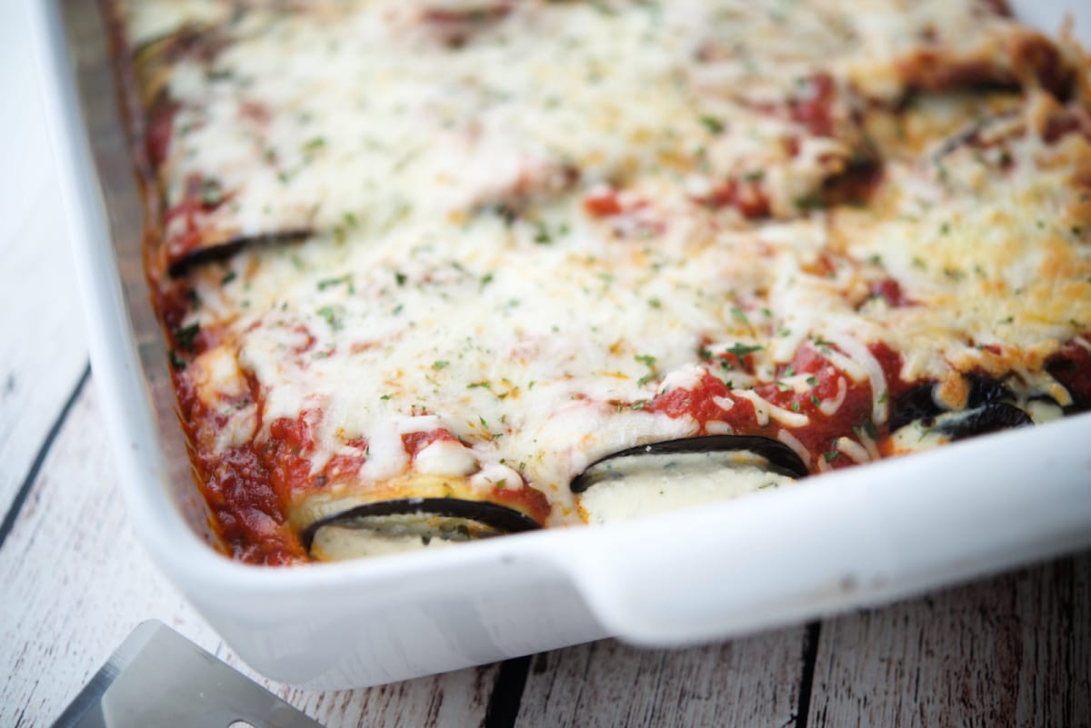 Rolled eggplant topped with sauce and cheese. 