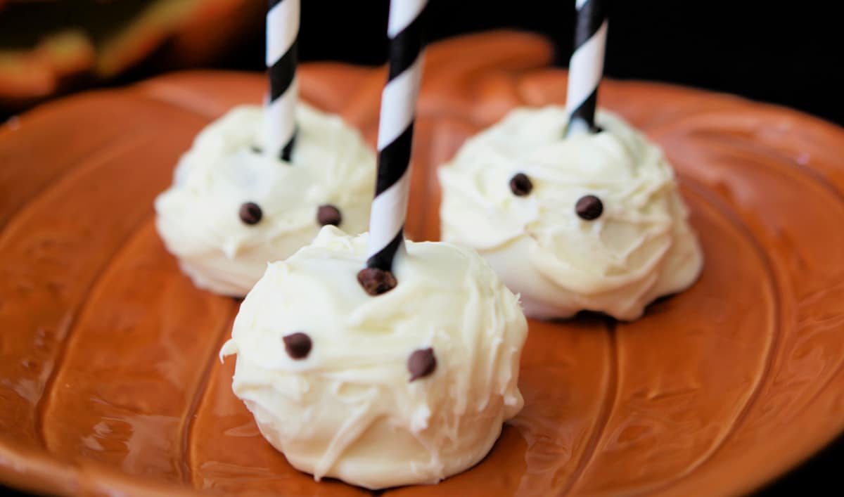 A close up of brownie pops that look like mummies