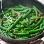 cooked green beans with bacon in a pan