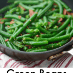 a close up of sautéed green beans in a pan