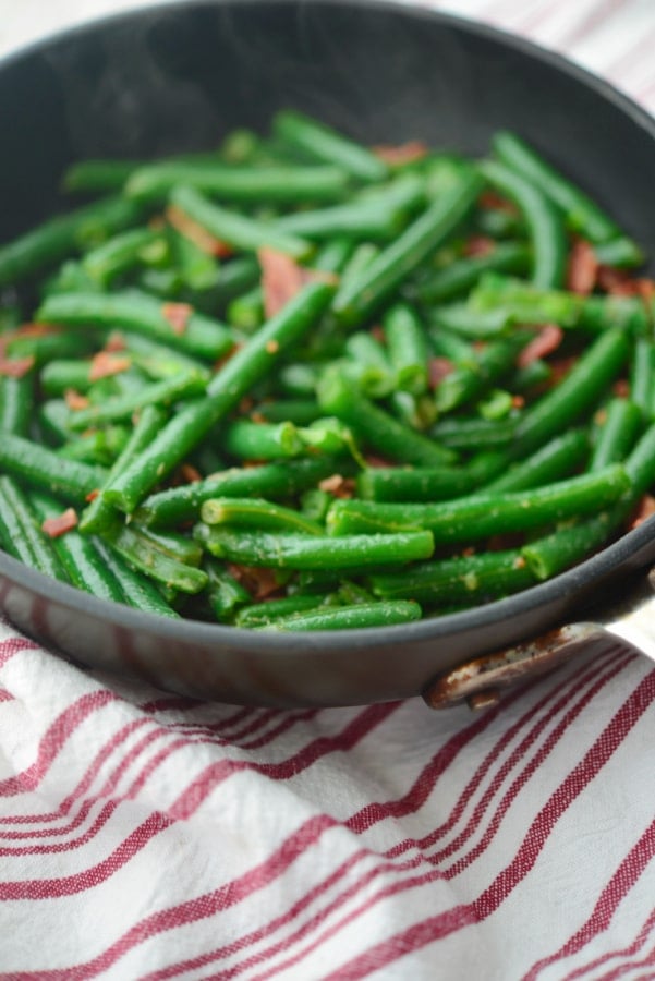 bacon and green beans in a nonstick skillet