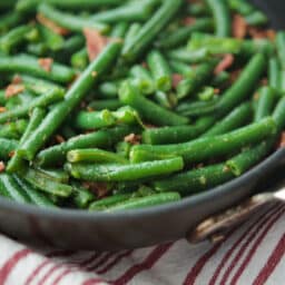a close up of green beans in a skillet