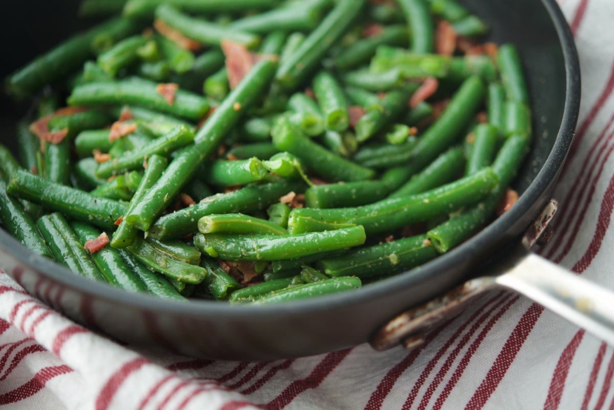a close up of green beans in a skillet