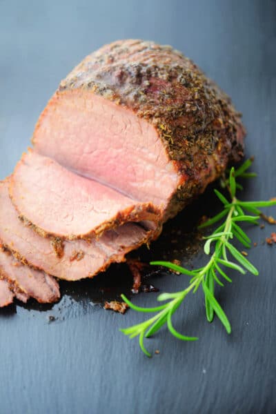 roast beef sliced on a gray board