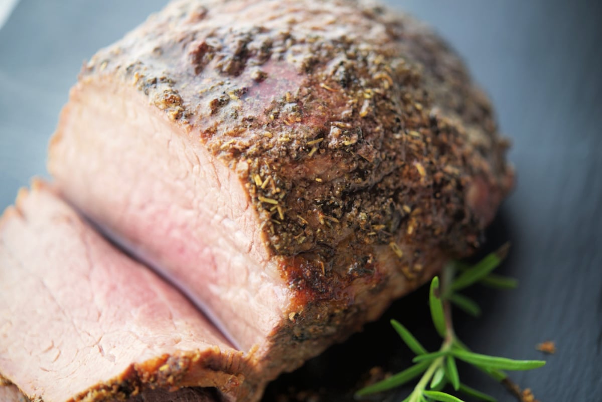 a close up of italian herbs on a roast