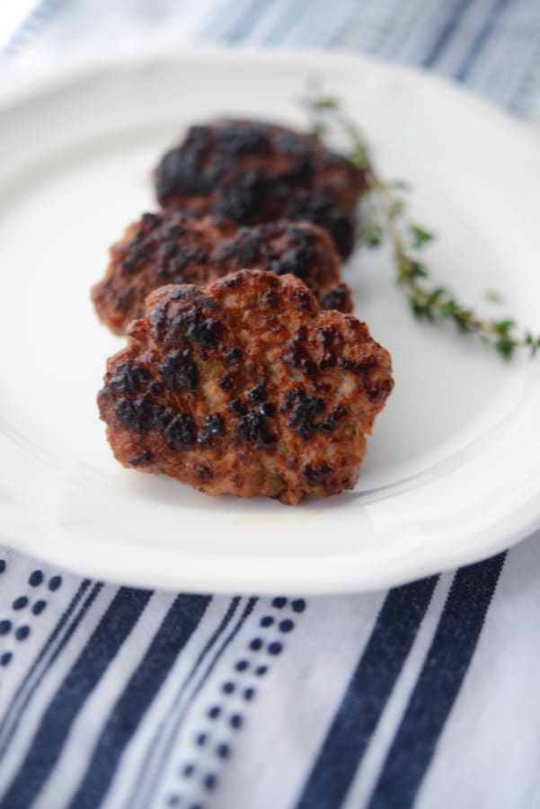 three breakfast sausage patties on a plate