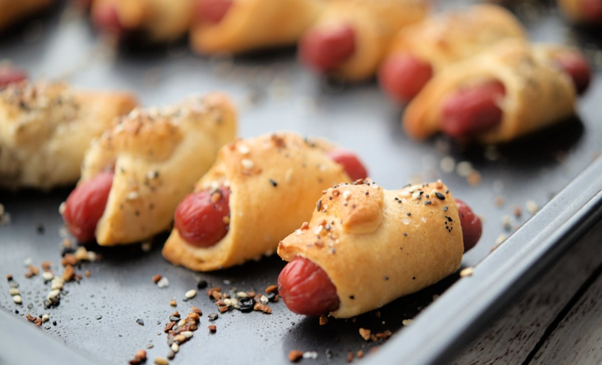 a close up of pigs in a blanket on a sheet pan