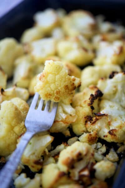 garlic roasted cauliflower on a fork